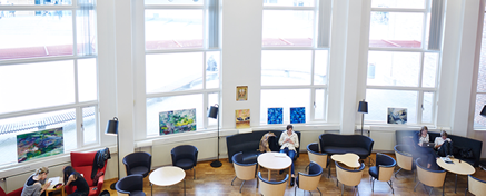 Student and staff in the open seating area in the library 