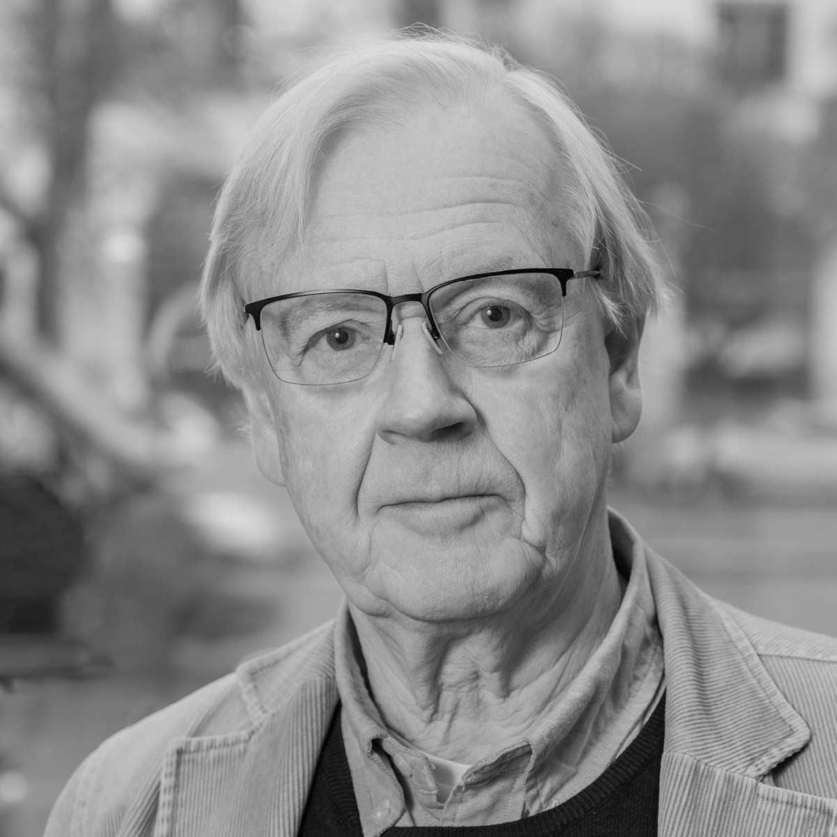 Man with glasses looking into camera